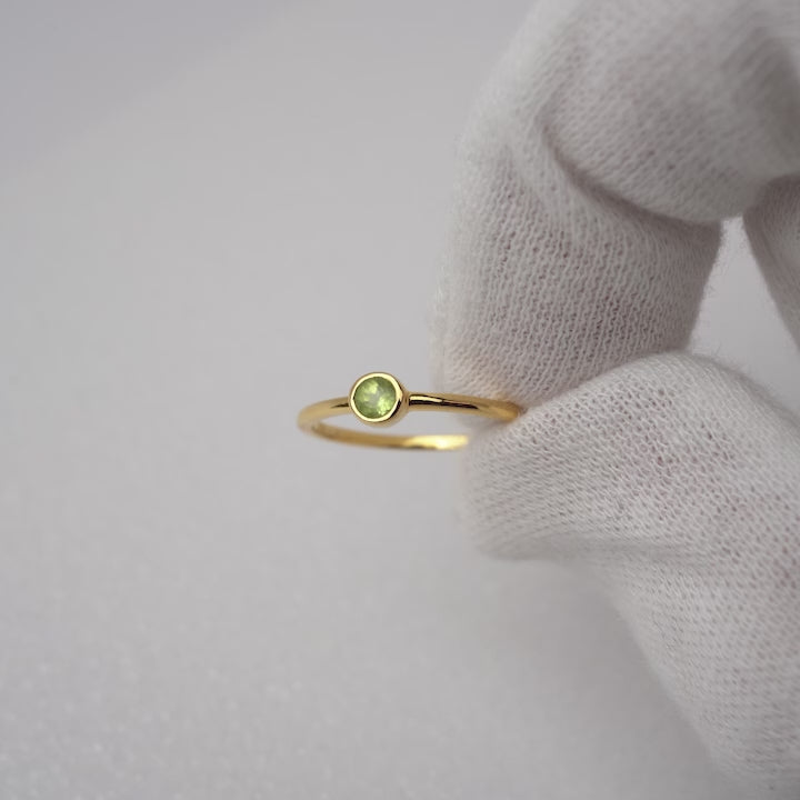 Goldring mit grünem Edelstein Peridot. Klarer und moderner Kristallring mit Peridot in Gold.